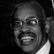 Black and white portrait of Mr. Thomas Bowser, smiling.